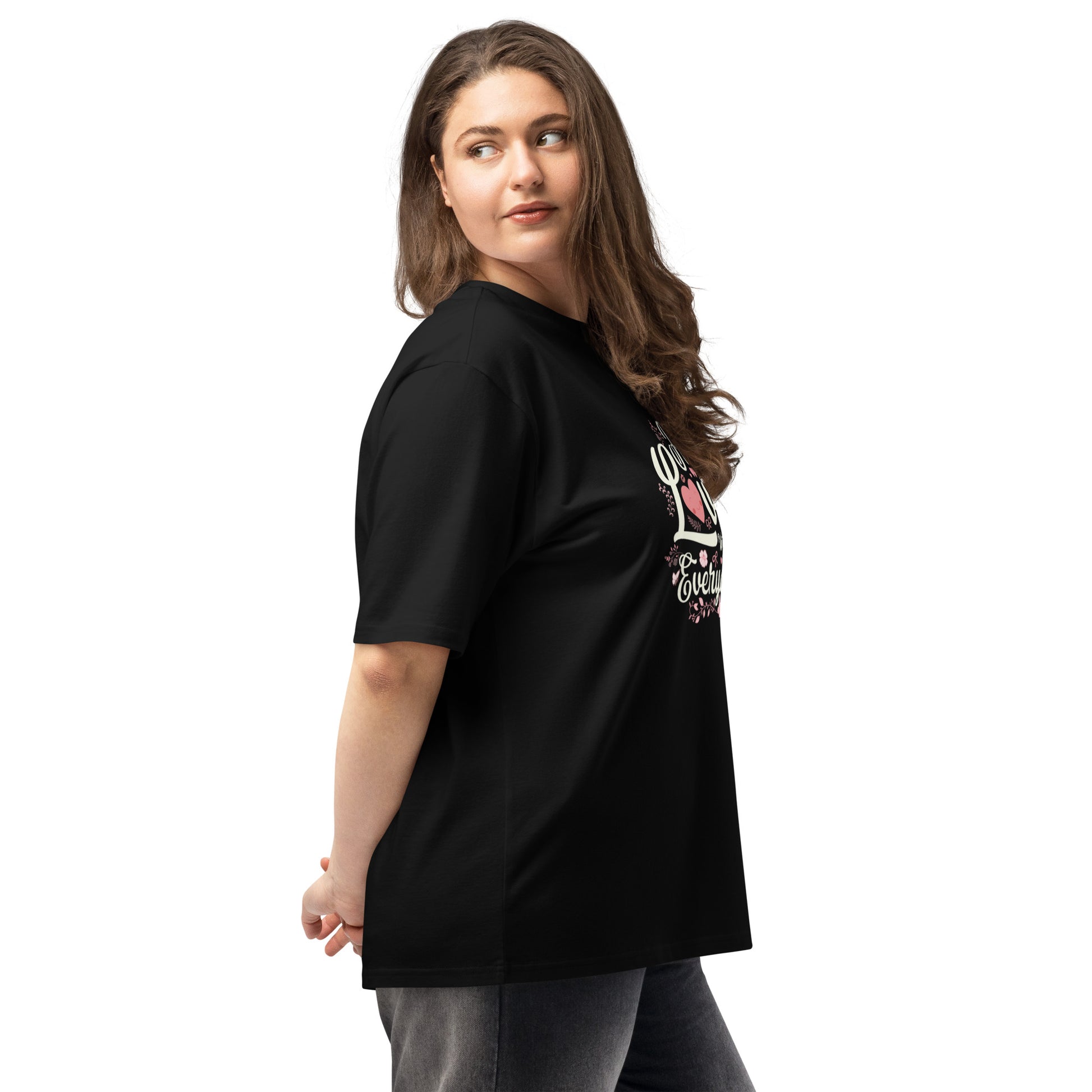 Woman wearing a black oversized heavyweight t-shirt featuring a graphic design, showcasing relaxed fit and comfort.