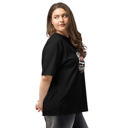 Woman wearing a black oversized heavyweight t-shirt featuring a graphic design, showcasing relaxed fit and comfort.